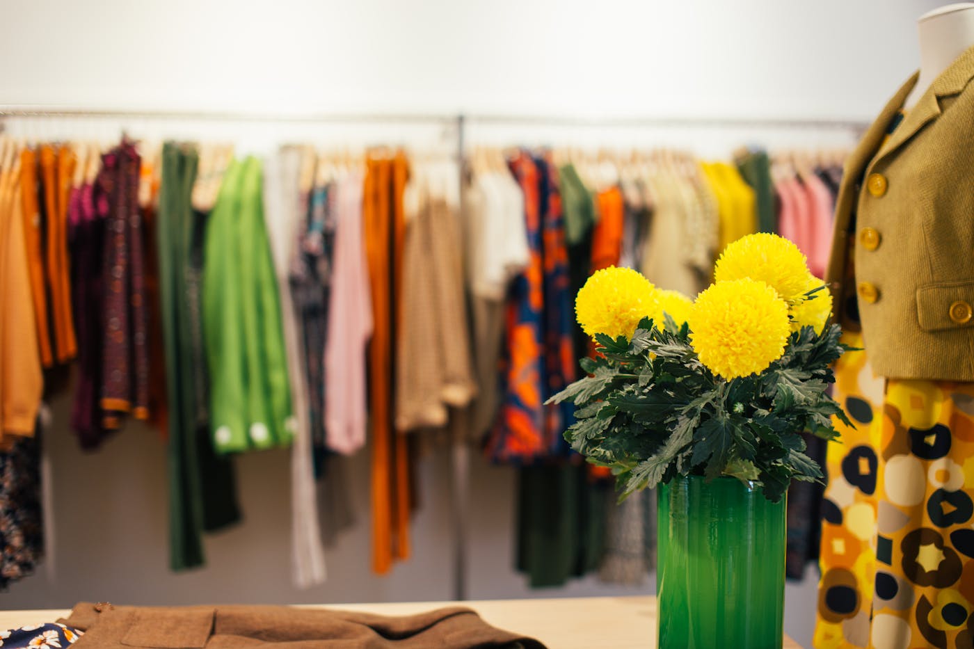 Curated colorful clothing rail in a fashion studio