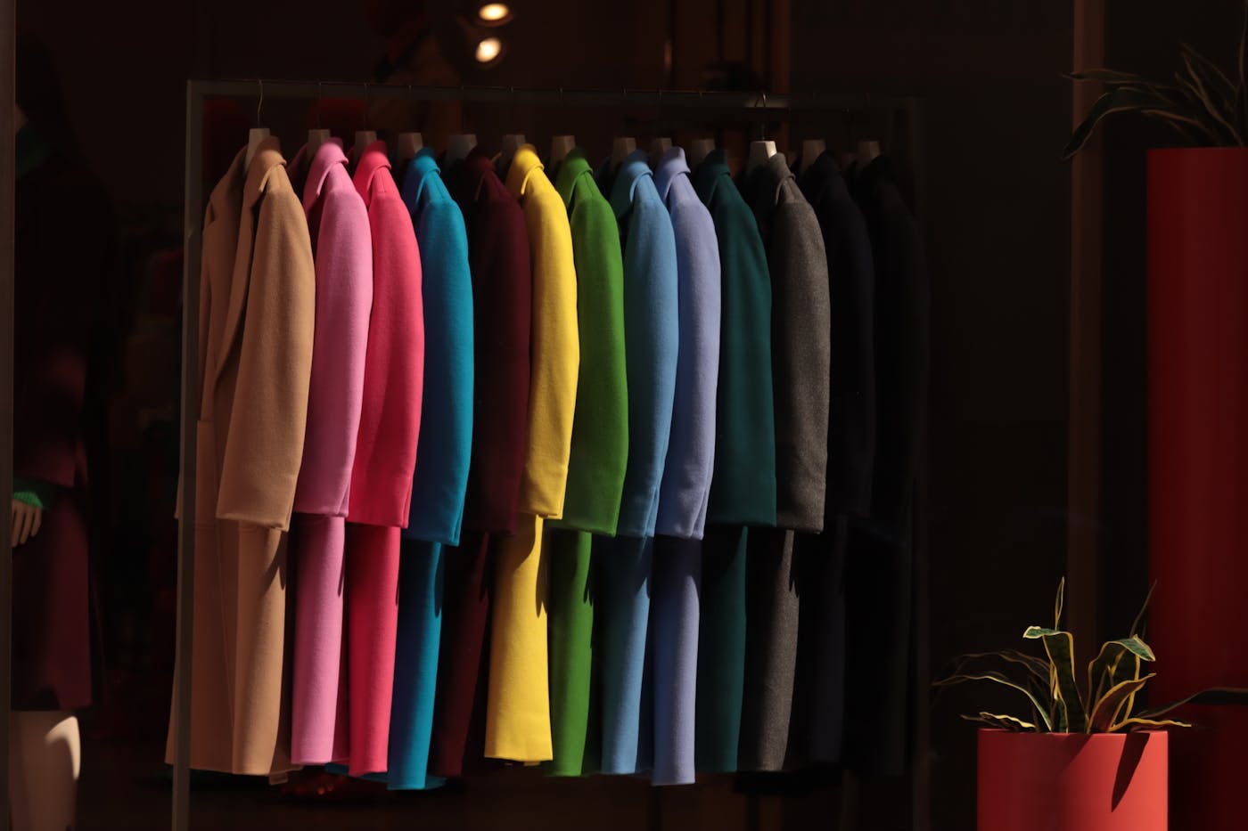 Brightly colored coats displayed in a premium store.